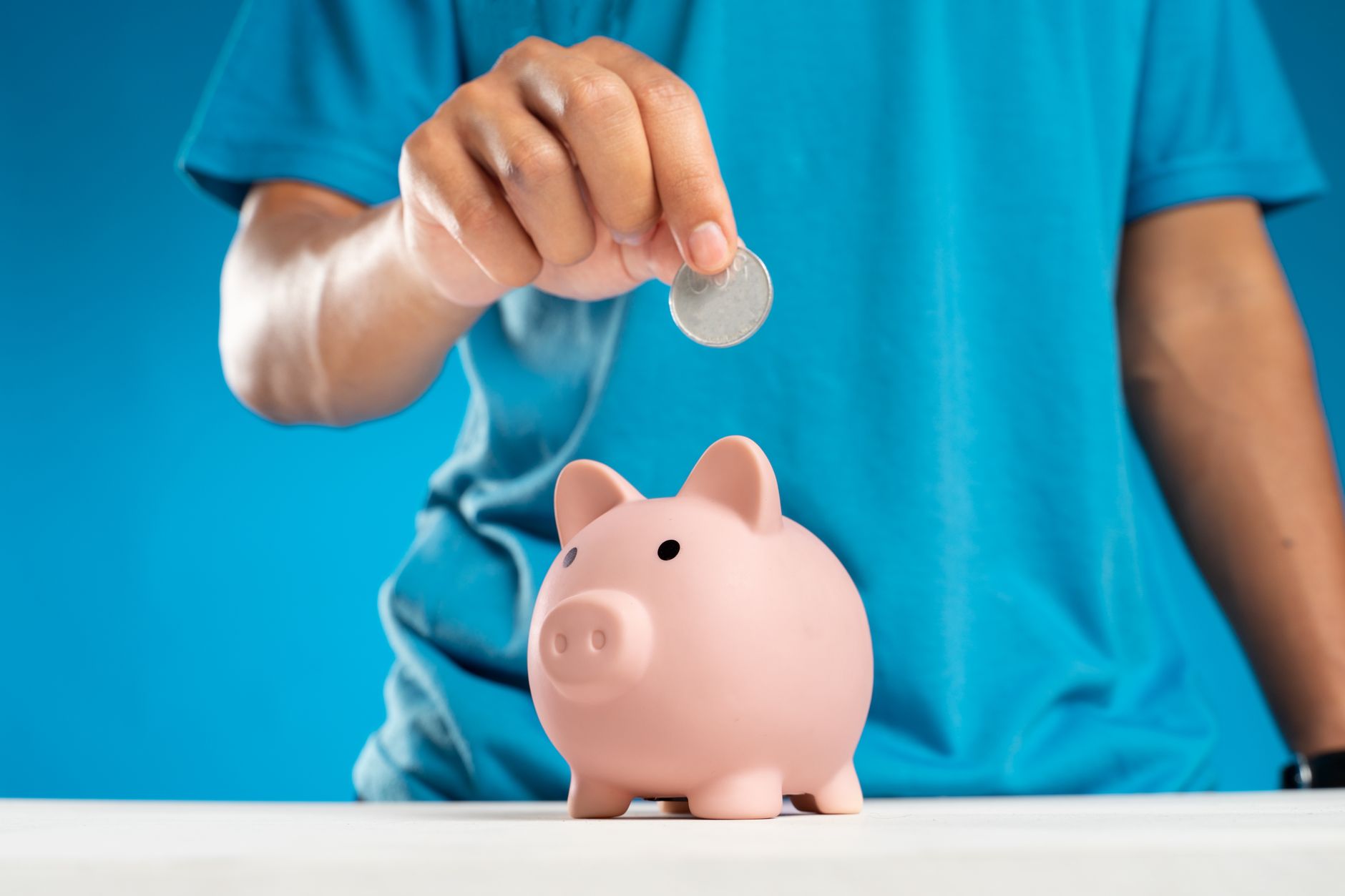 Person planning retirement income with financial documents and calculator
