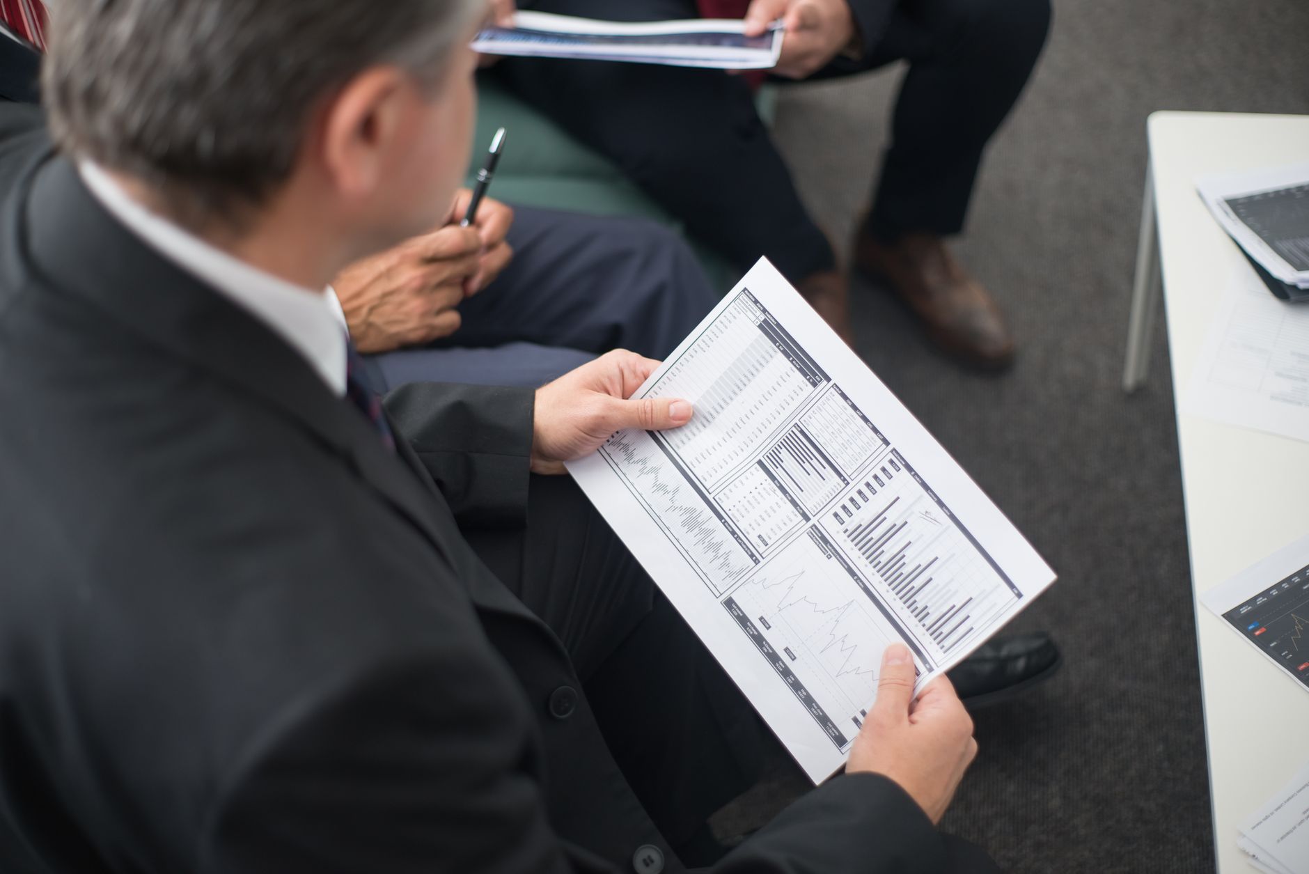 Two financial professionals discussing portfolio strategy in a modern office setting