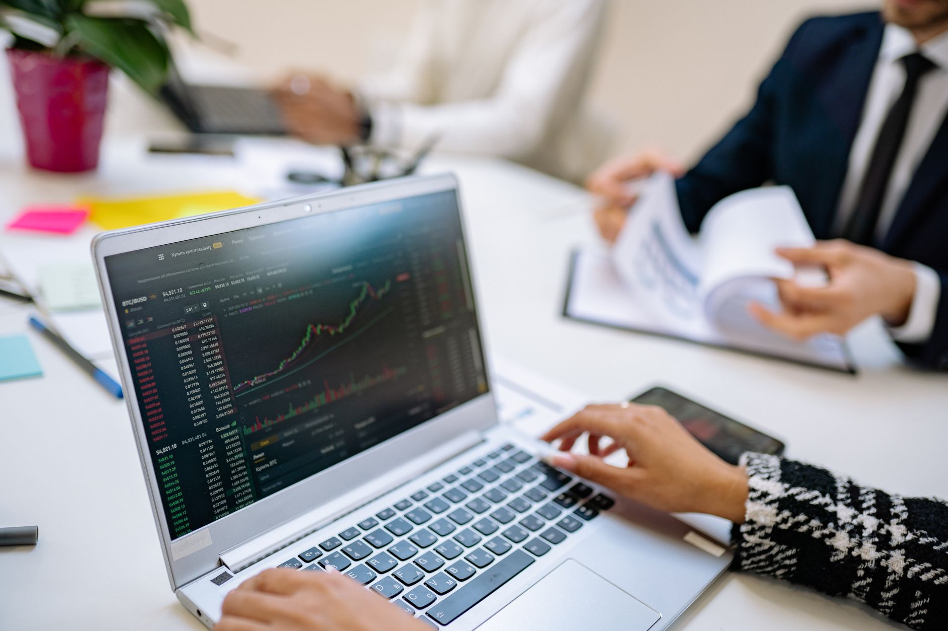 Institutional investors reviewing portfolio strategy documents in a conference room