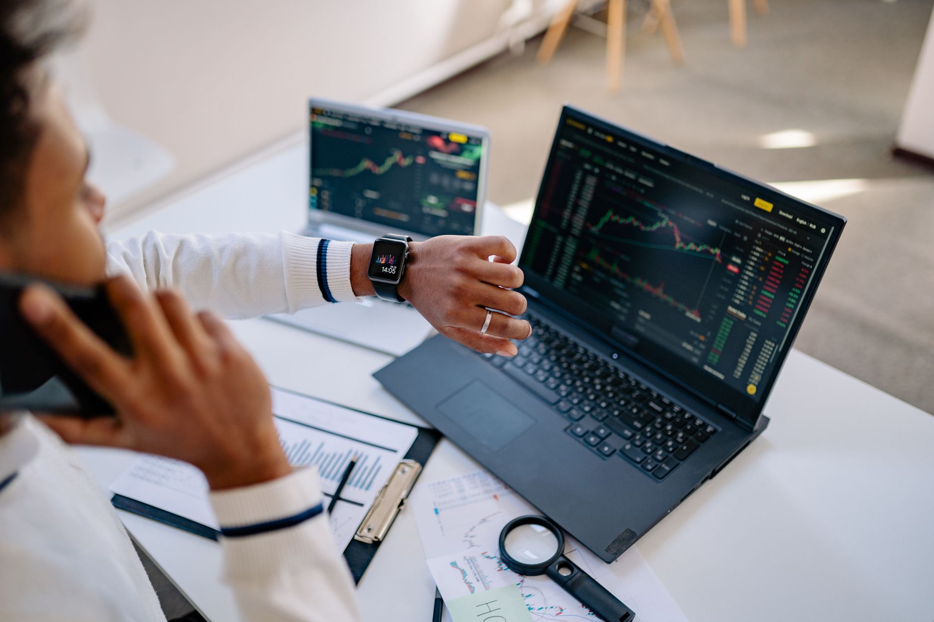 Investor reviewing financial data and portfolio performance on a computer screen
