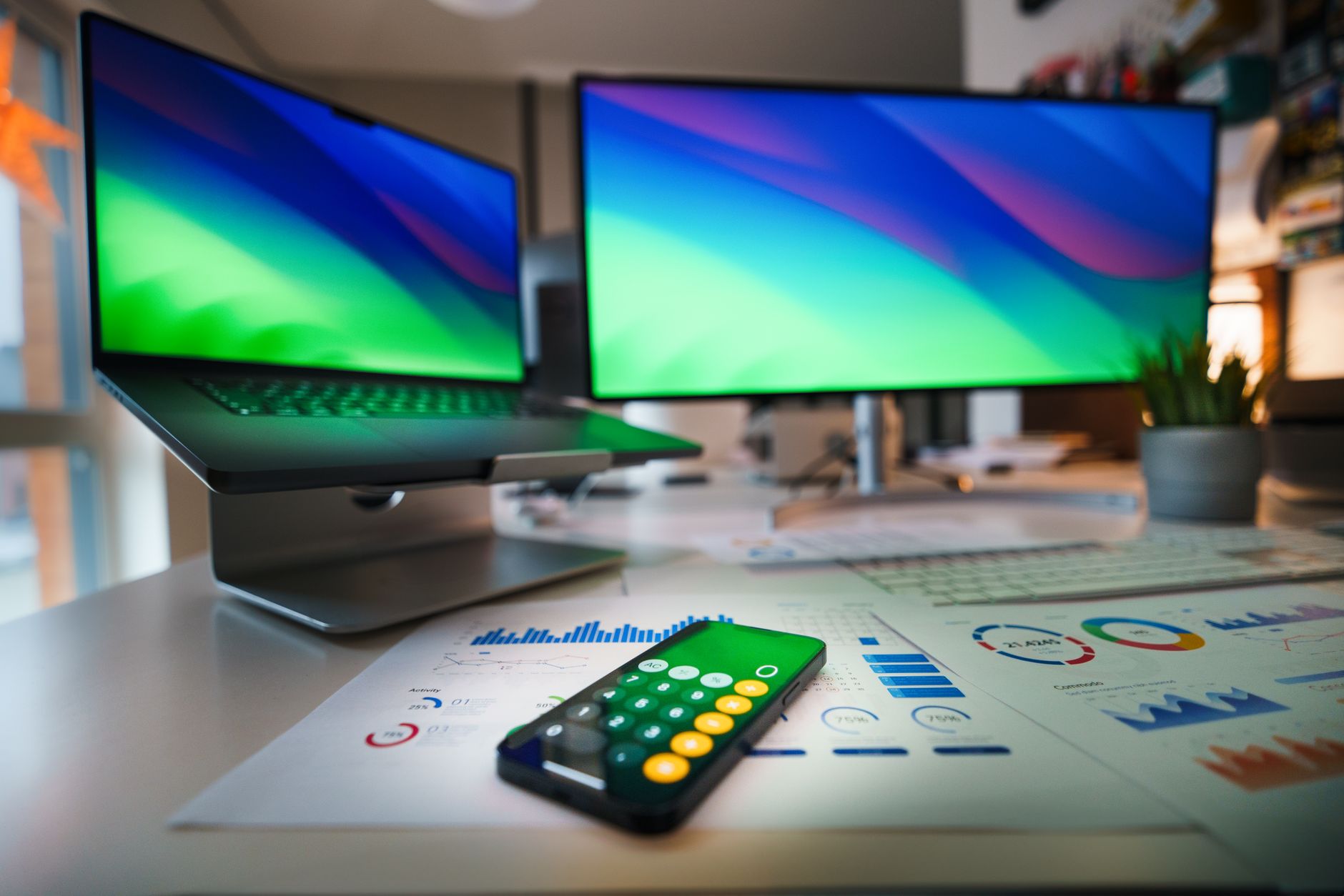 Investor reviewing financial documents at a desk with a laptop