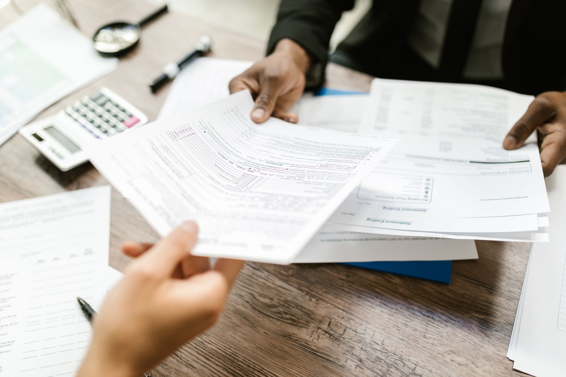 Business documents spread on desk representing corporate spin-off filing and separation paperwork