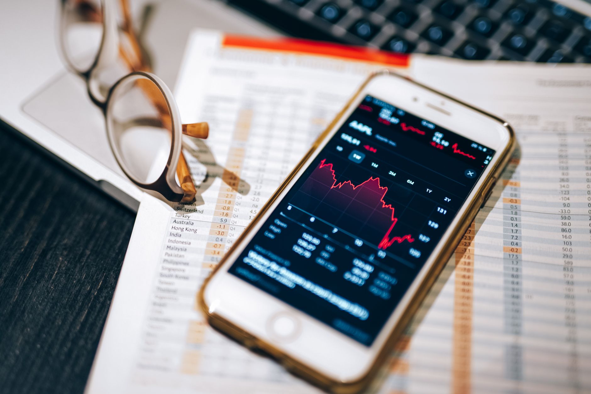 Investment analyst reviewing multiple data screens at a trading desk