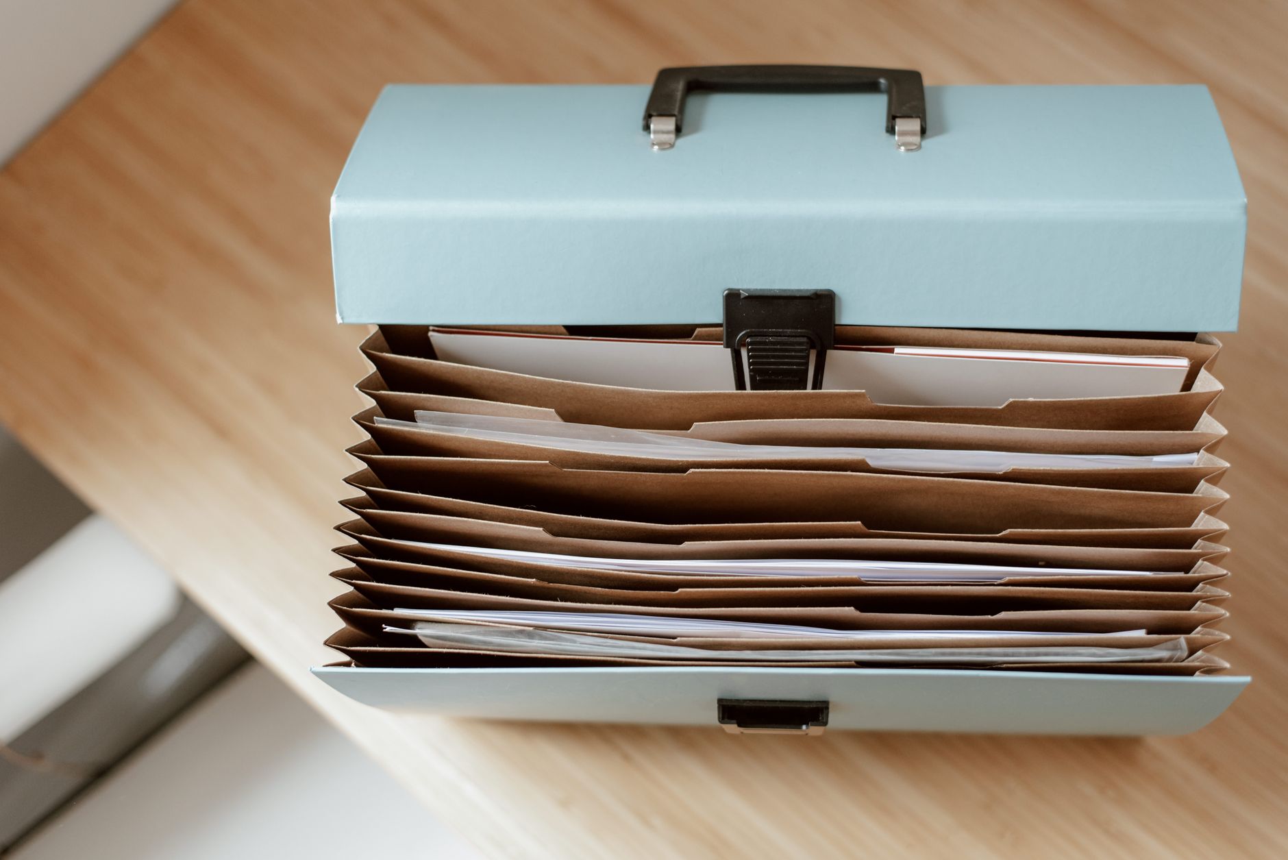 Investment portfolio documents and charts spread across an office desk