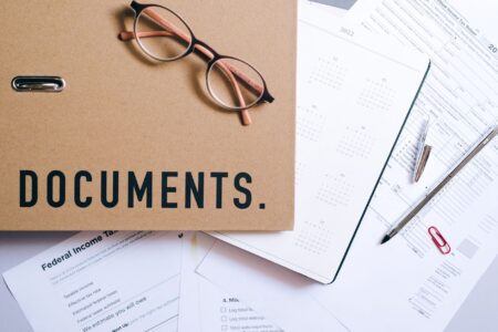 Collateralized Loan Obligations Draw Scrutiny as Spreads Compress Financial documents and spreadsheets spread across a desk representing structured credit analysis
