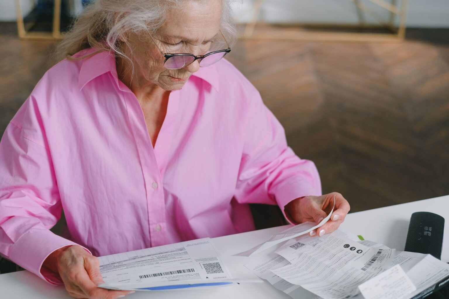 Senior couple reviewing retirement financial documents at a desk