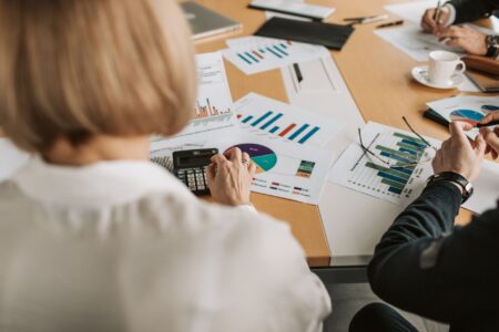 Structured Credit Secondaries Quietly Draw Family Office Allocators Business professionals reviewing financial documents at a conference table
