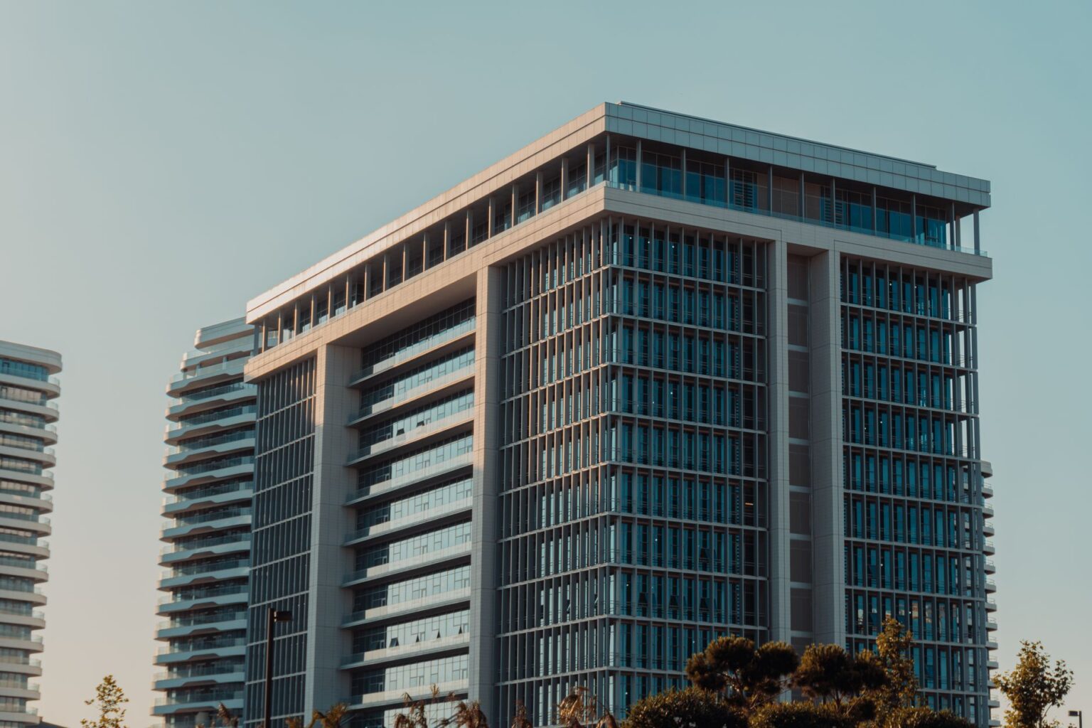 Preferred Equity REITs Quietly Absorb Yield Demand as Cuts Stall Modern commercial real estate building exterior representing REIT property assets