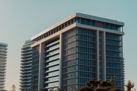 Preferred Equity REITs Quietly Absorb Yield Demand as Cuts Stall Modern commercial real estate building exterior representing REIT property assets