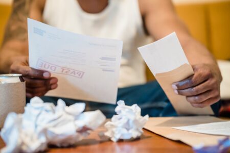 Pay-In-Kind Toggle Notes Quietly Resurface Among Stressed Borrowers Close-up of financial documents representing corporate debt instruments and bond agreements