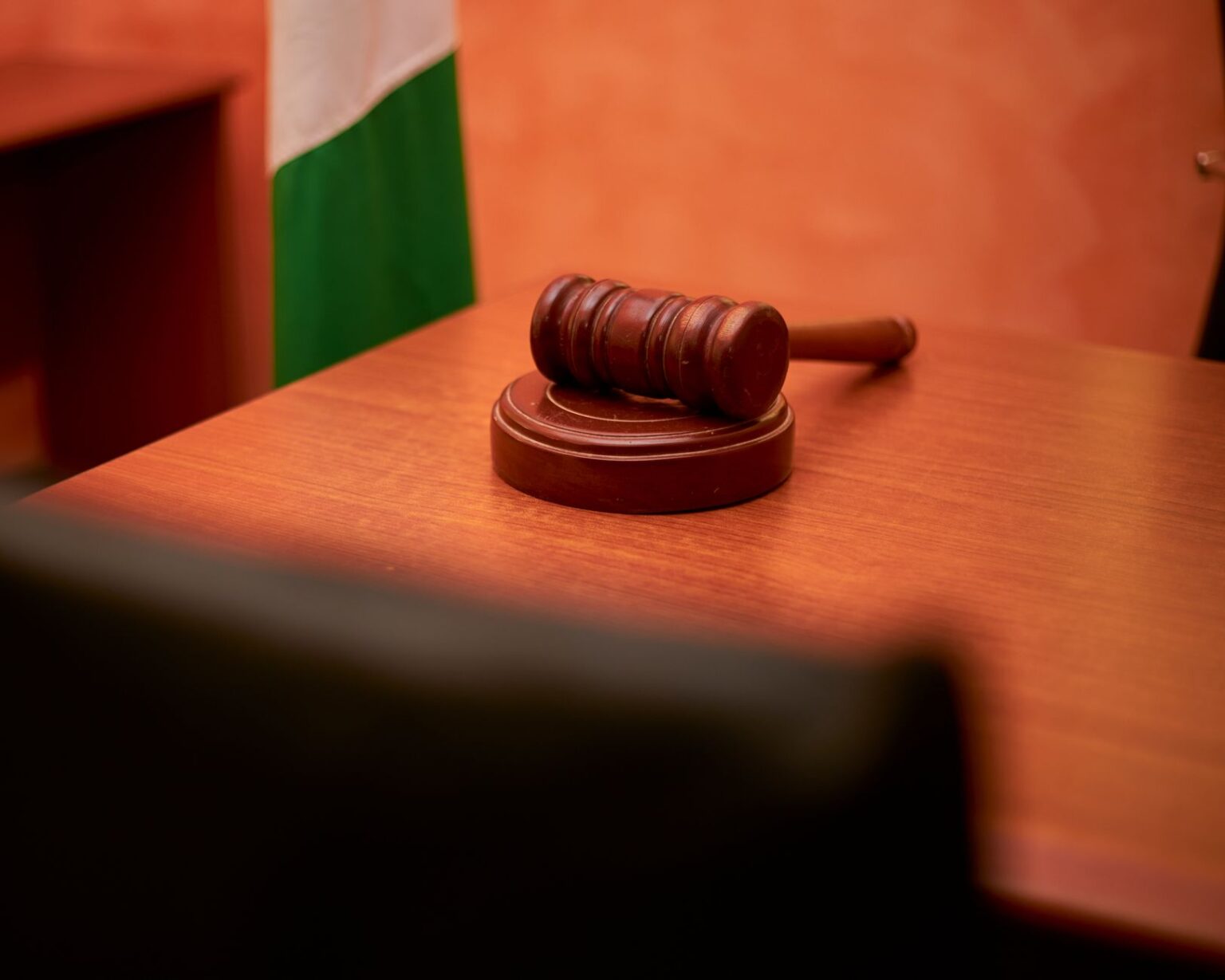 Empty courtroom with wooden benches and judge's bench representing litigation finance investment