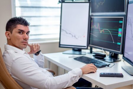 Multiple trading screens displaying stock market volatility data and ETF price movements