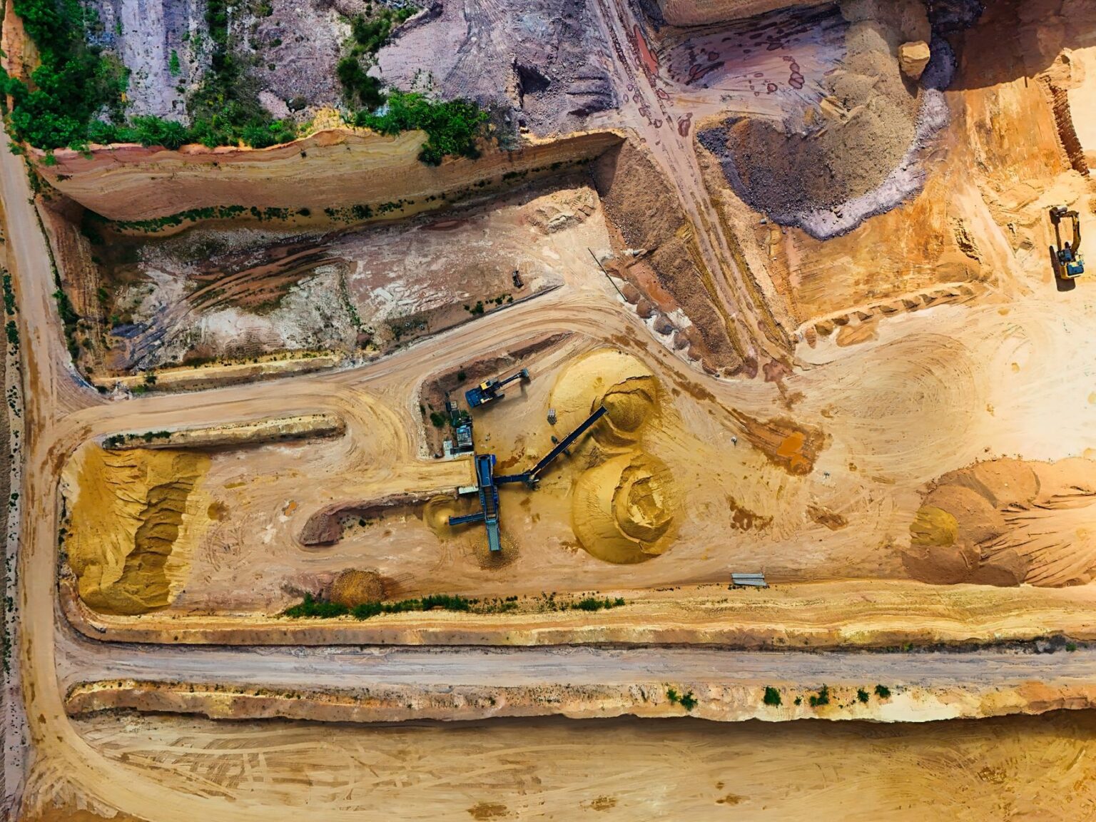 Commodity Supercycle Bets Quietly Resurface Among Macro Allocators Open pit copper mine showing large-scale raw material extraction operations