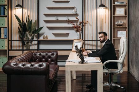 Ultra-high-net-worth investors reviewing financial documents in a private office setting