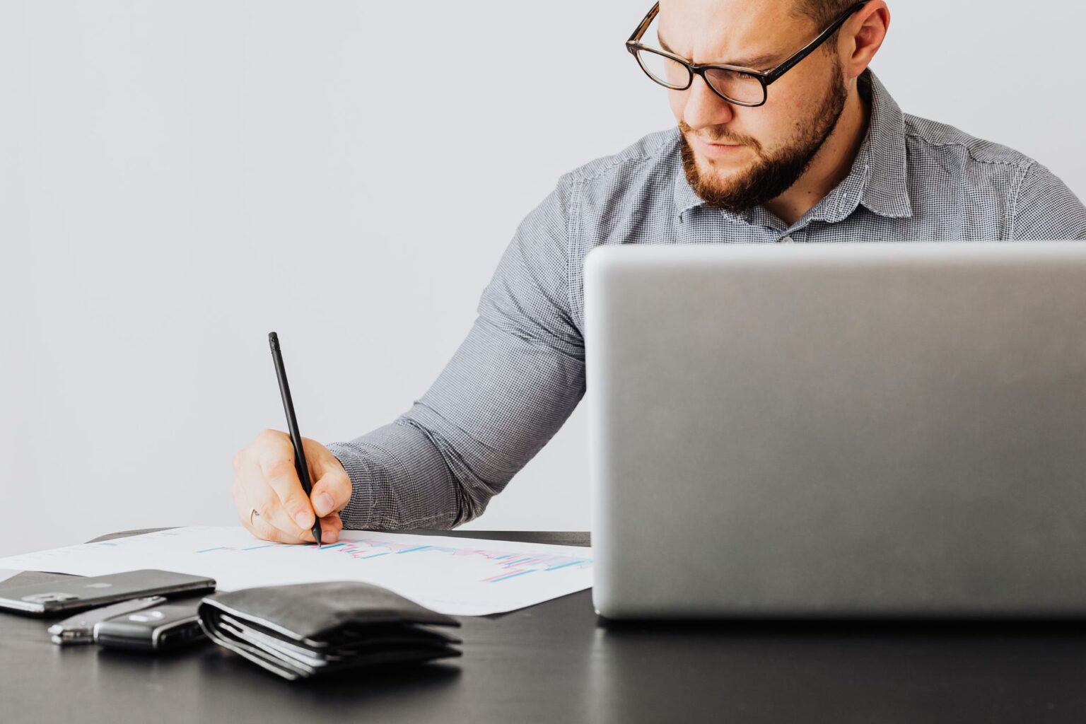 Financial documents and charts spread across a desk representing portfolio cash management