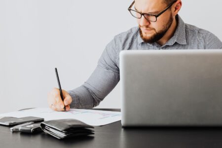Financial documents and charts spread across a desk representing portfolio cash management