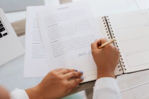 Two professionals signing a financial contract at a desk, representing royalty streaming agreements