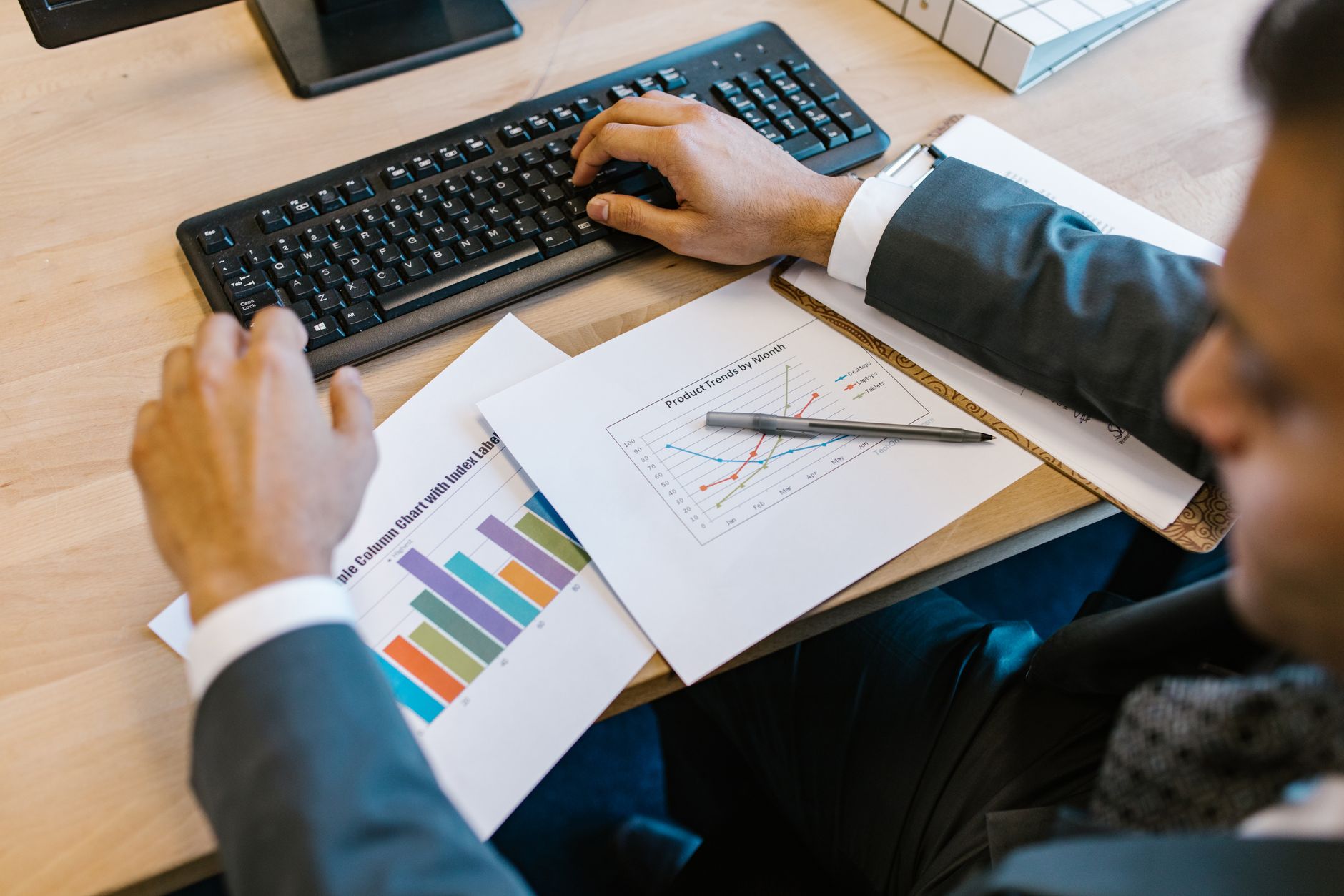 Financial charts and data on a trading desk representing structured finance analysis