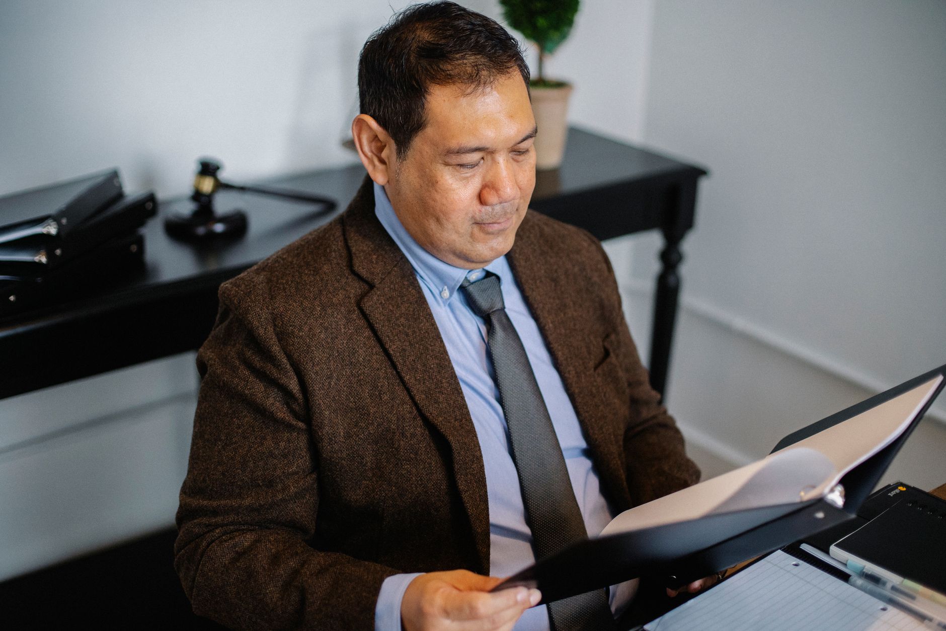An investor reviewing financial documents and portfolio statements at a desk