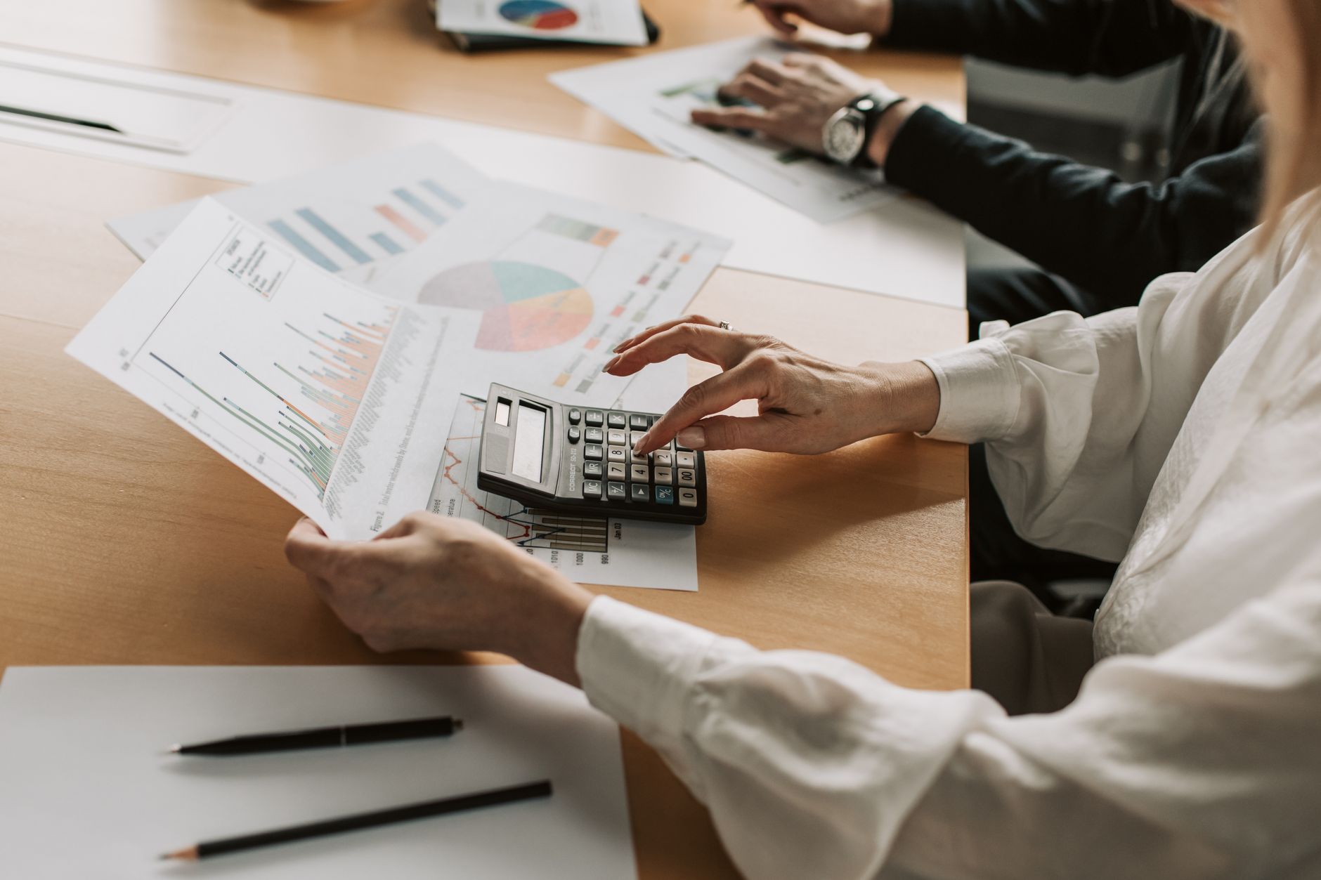 Finance professionals reviewing investment strategy documents in a conference room