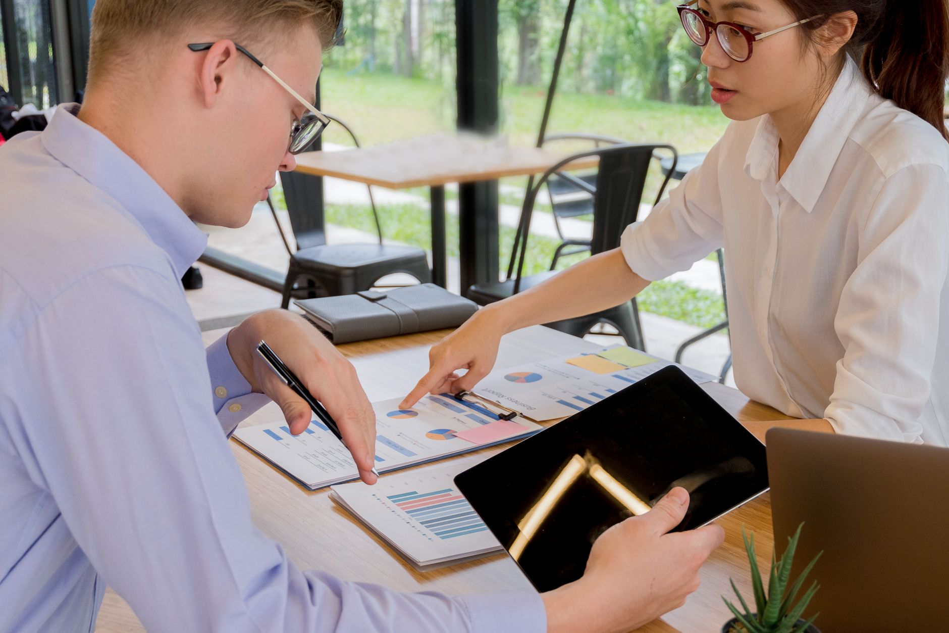 Professional reviewing investment allocation documents during a financial planning session