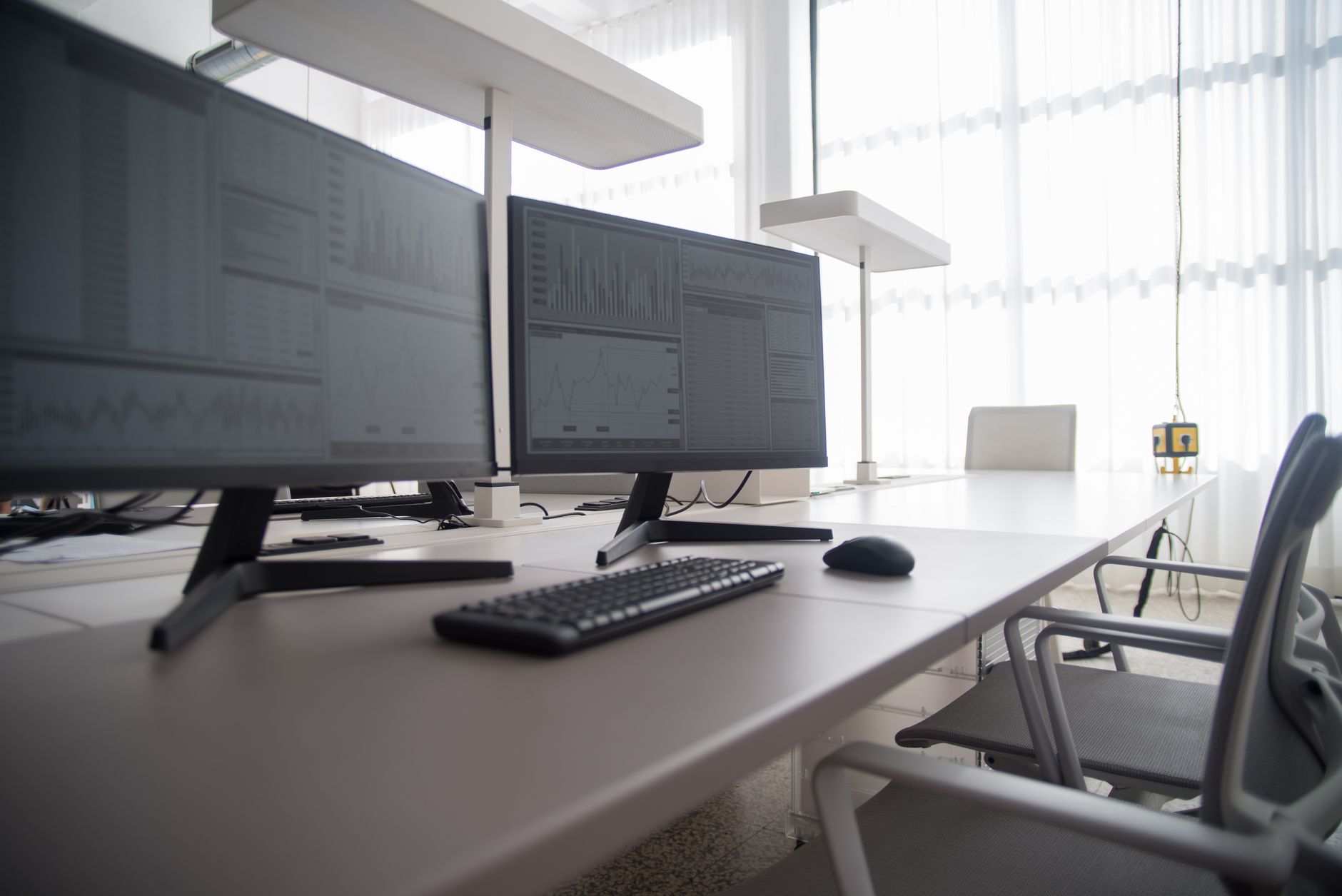 Investment professionals reviewing financial instruments and risk data at a desk