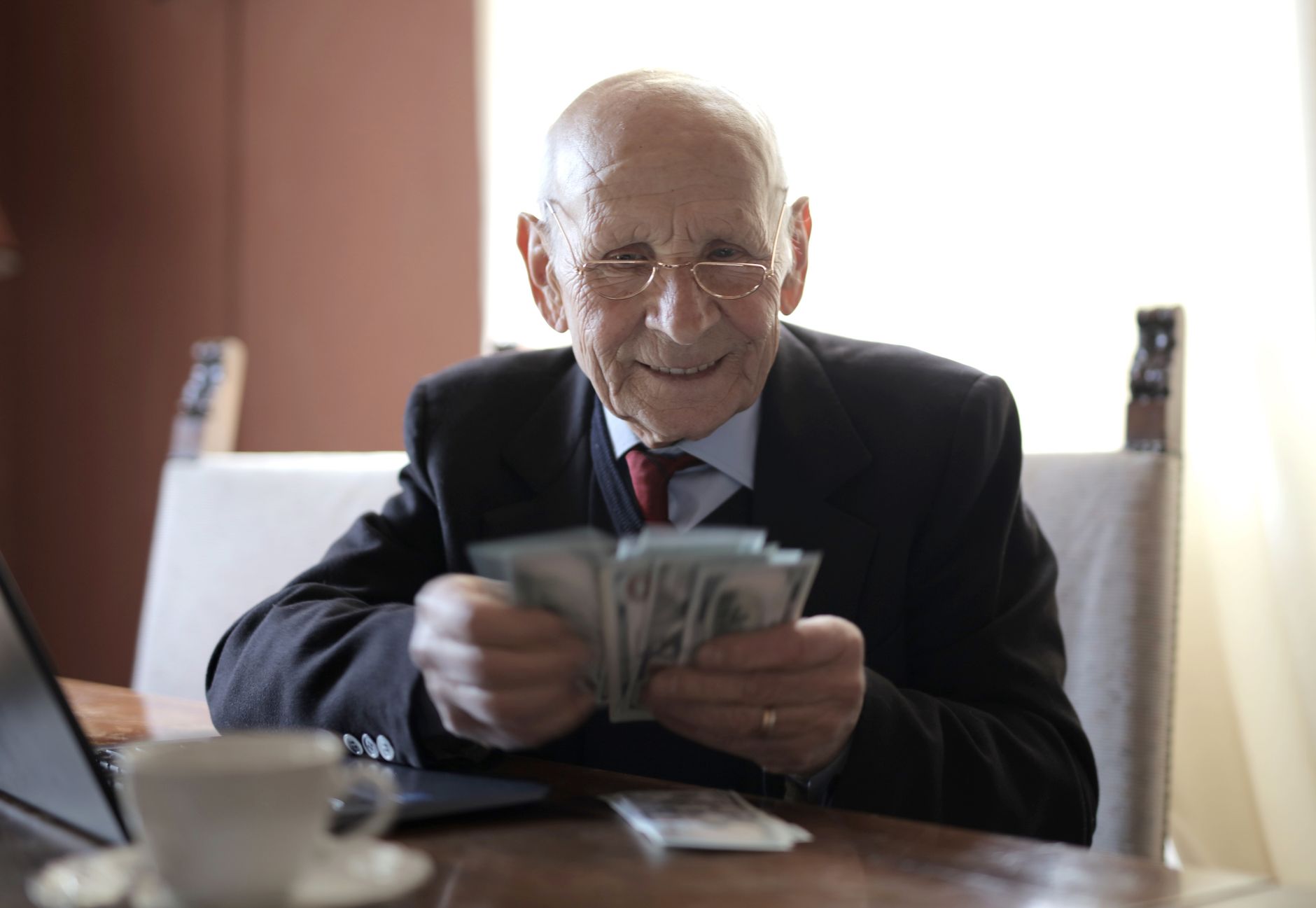 Senior professional man reviewing paperwork at an office desk