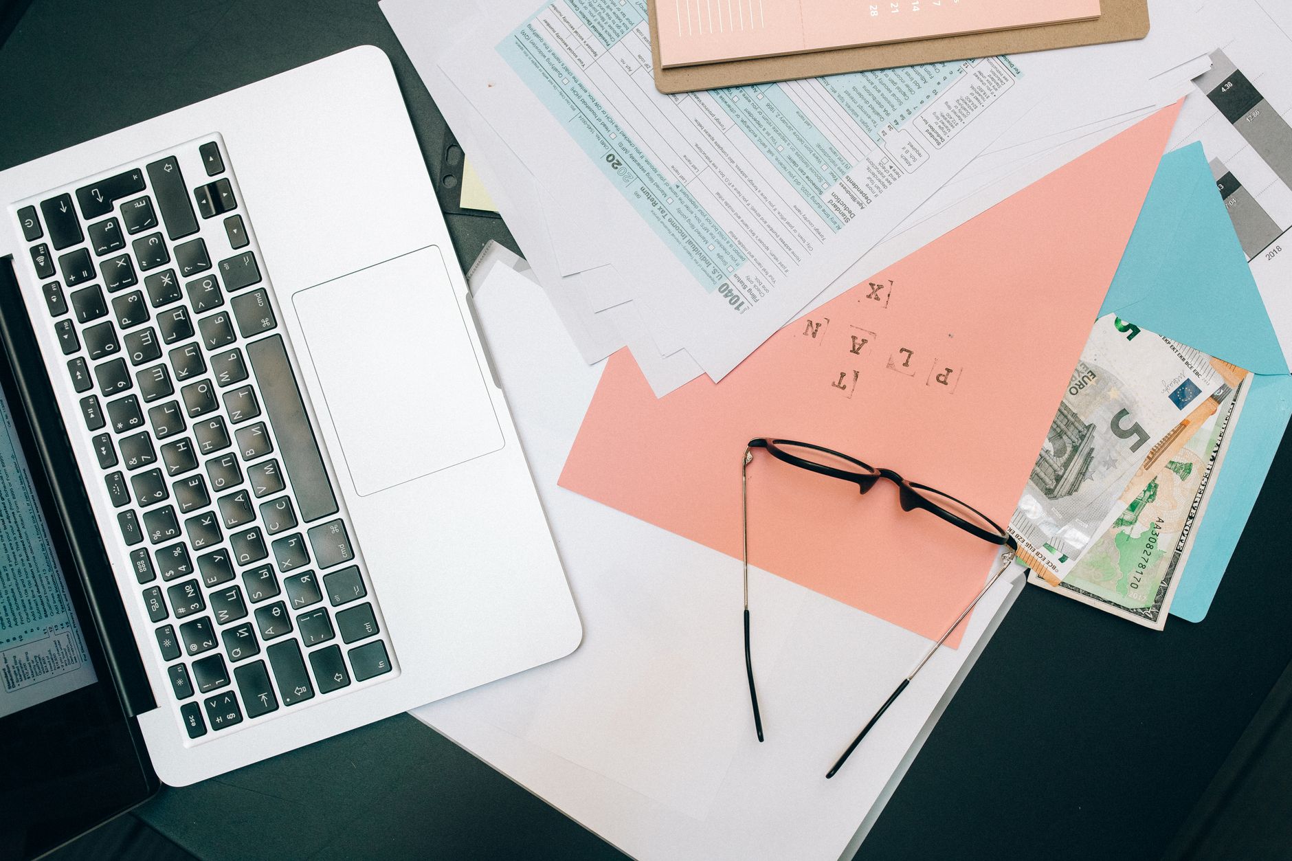 Professional reviewing financial planning documents and bond schedules at a desk