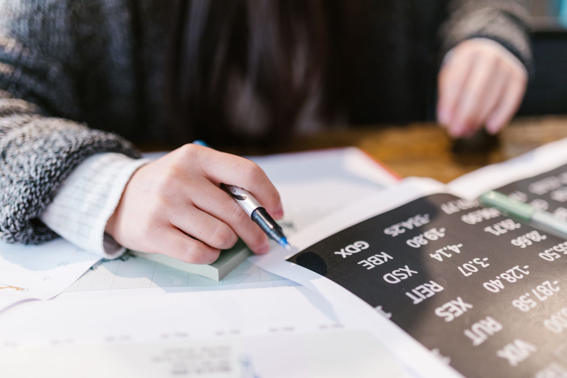 Investor reviewing portfolio documents and financial analysis at a desk